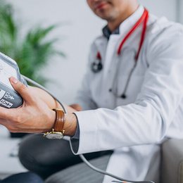 A doctor checking a patient's blood pressure