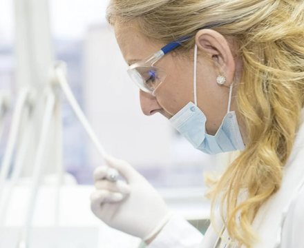 A laboratory specialist at work in a bright medical lab